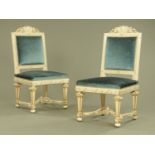 A pair of white and gilt painted side chairs, with upholstered backs and seats.