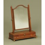 A 19th century mahogany toilet mirror, with arched top, angled supports,