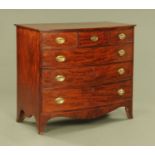 An early 19th century mahogany bowfronted chest of drawers,