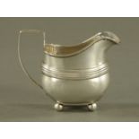 A George III silver cream jug, London 1811, 165 grams.