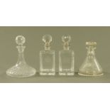 A cut glass ships decanter, another similar and a pair of square form decanters.