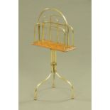 A Victorian brass and oak floor standing magazine rack. Height 76 cm, width 35 cm.