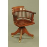 A Victorian mahogany desk chair, with bowed top rail, outswept arms,