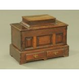 An 18th century small oak Bach coffer, with hinged box top, three panelled front,