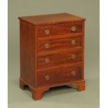 An Edwardian mahogany chest of four graduated drawers,