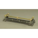 A late Victorian cast iron and brass fire curb. Internal length 97 cm, return 27 cm.