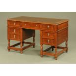 A 1920's oak pedestal desk, with leatherette writing surface,