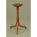 A George III mahogany candle stand, with dished top, turned column and three downswept legs.