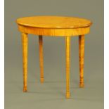 A satin walnut oval occasional table, raised on four tapered legs of square section. Width 81 cm.