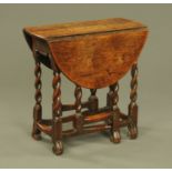 A small 18th century oak gate leg table, with twist column supports and toupie feet.