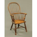 A 19th century Windsor armchair, with solid seat, turned legs and turned stretchers.