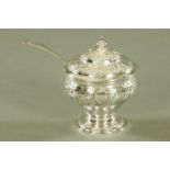 A George III embossed silver table salt, with blue glass liner and plated spoon,