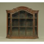 A Victorian glazed hanging cabinet, with shaped pediment,
