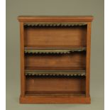 A Victorian mahogany open bookcase, with moulded cornice adjustable shelves and plinth base.