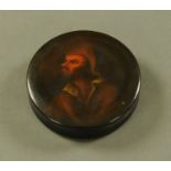 A Stobwasser type papier mache snuff box decorated with a male bust. diameter 9.5 cm.