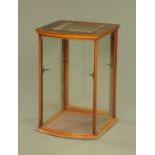 A Victorian mahogany framed shop display cabinet, bowfronted with rear opening door.