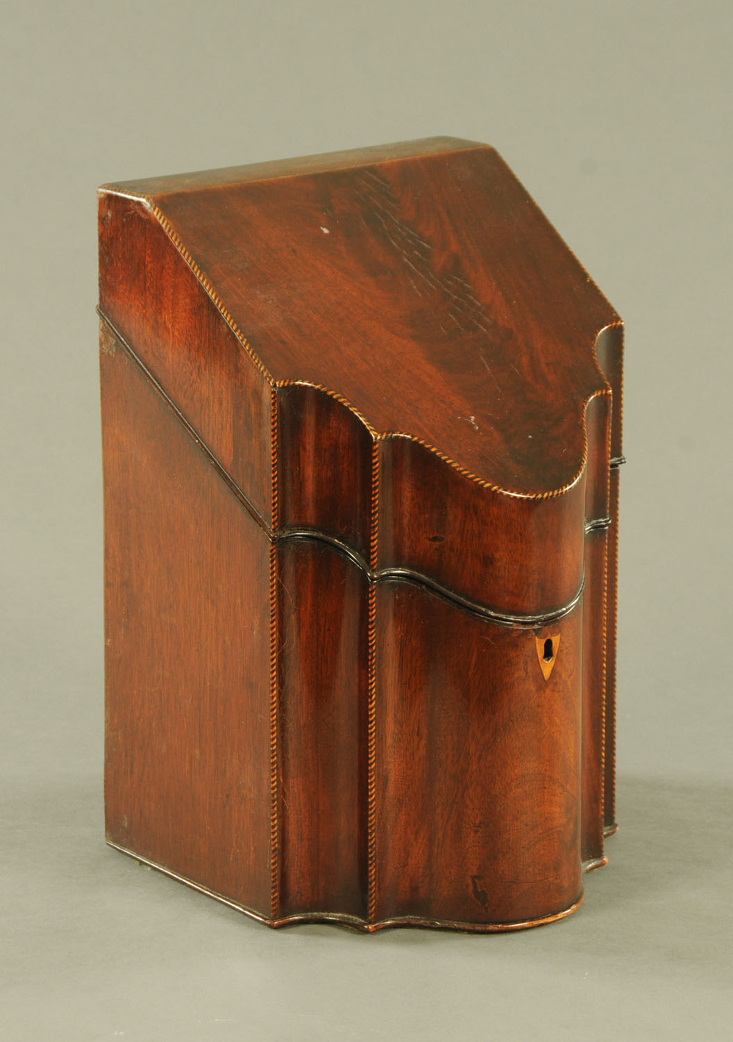 A George III mahogany serpentine fronted knife box, complete with fitted interior. Width 22.