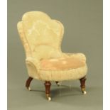 A Victorian ladies chair, with shaped stuffover back, low arms and seat,