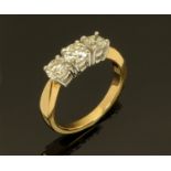 An 18 ct yellow gold three stone diamond ring, diamonds +/- 1.23 carats, size M.