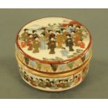 A Satsuma circular lidded casket, allover decorated with figures and with seal mark to base.