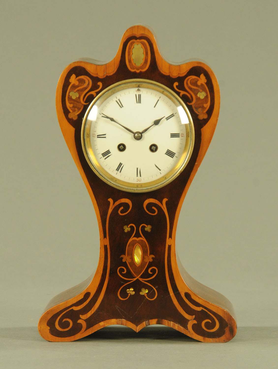 An Edwardian Art Nouveau inspired shaped mantle clock,