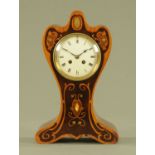 An Edwardian Art Nouveau inspired shaped mantle clock,
