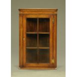 A Titchmarsh & Goodwin oak hanging corner cabinet, with canted angles,