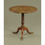 A Georgian oak snap top tripod occasional table, with turned column and three downswept legs.