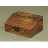 A 17th century oak bible box, with slope front with carved frieze initialled EC.