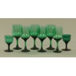 A set of six early 20th century green wine glasses, height 18 cm, and a pair.