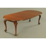 A mahogany extending dining table with three leaves, circa 1930,