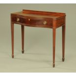 A George III style mahogany serpentine fronted side table, the drawer with plaque Hampton's London,