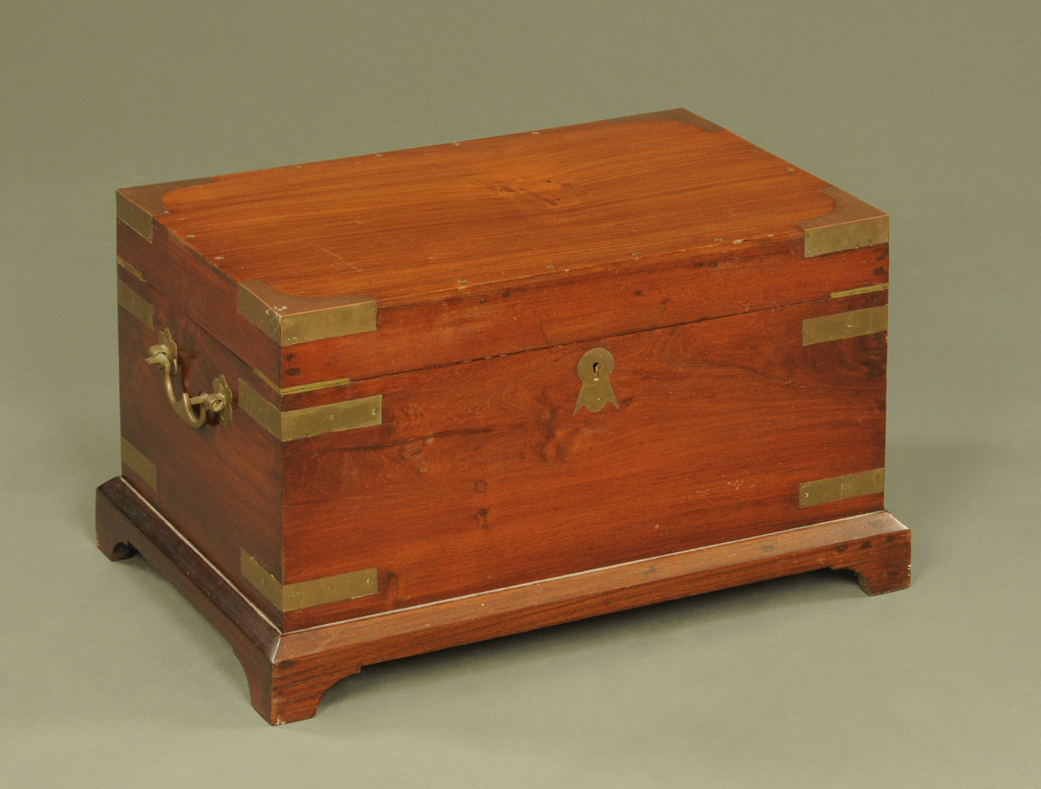 An Indian brass bound rectangular casket, with carrying handle to either side.