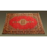 A large Persian rug with centre medallion,