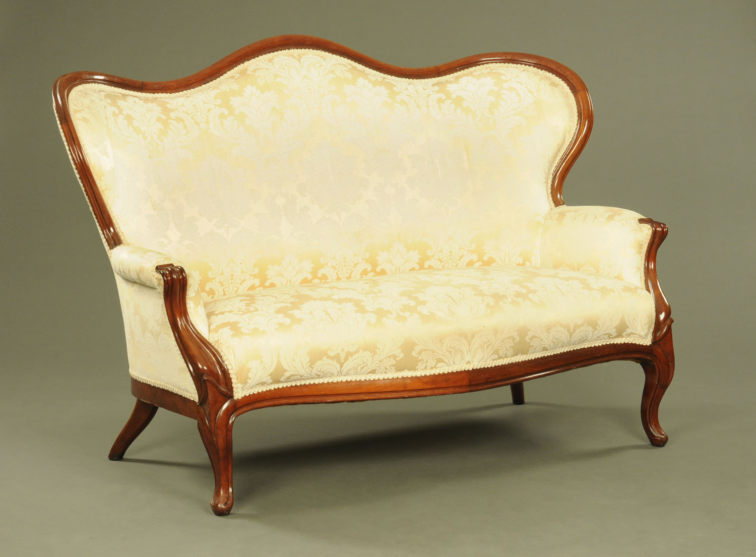 A Victorian walnut framed settee, with moulded exposed showframe and upholstered back,