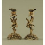 A pair of 19th century Black Forest carved candlesticks,