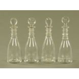 A set of four early 19th century club shaped decanters, each with three ringed neck.