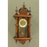 A walnut cased Vienna style regulator wall clock, with two train spring driven movement.