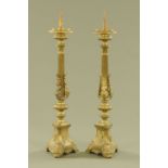 A pair of late 19th century brass continental pricket form candlesticks,