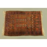 An eastern fringed prayer rug, with fringed ends, principal colours purple, beige and blue.