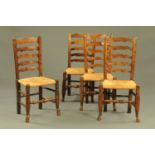 Four 19th century rush seated ladder back dining chairs.