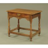 An 18th century oak side table, with moulded edge and frieze drawer with shaped apron,