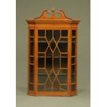 A George III mahogany hanging corner cupboard,