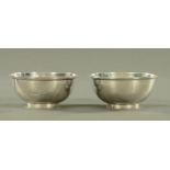 A pair of George III silver bowls by Charles Kandler II, each with beaded rim,