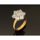 An 18 ct gold two tone seven stone cluster ring, +/- 3.27 carats, size L.