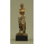 A bronze figure of Venus de Milo, raised on a black marble plinth. Height 28 cm.