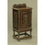 A Victorian carved oak side cabinet, with rear upstand,