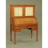 A 19th century Continental walnut cylinder bureau bookcase, with glazed upper section,