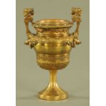 A bronze two handled foliate moulded urn, with Greek key decoration. Height 23 cm.