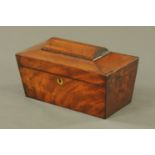 A George III mahogany sarcophagus shaped tea caddy, with two interior divisions and open aperture.